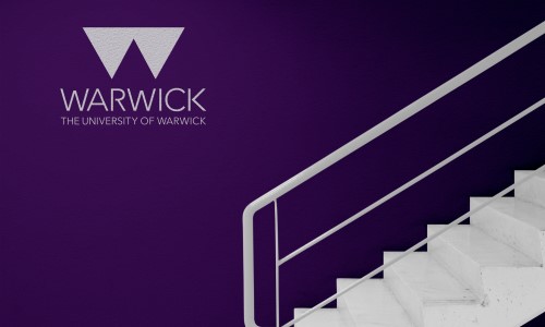 The University of Warwick logo printed on a wall