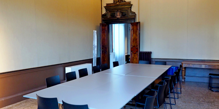 A seminar room with many chairs around a table