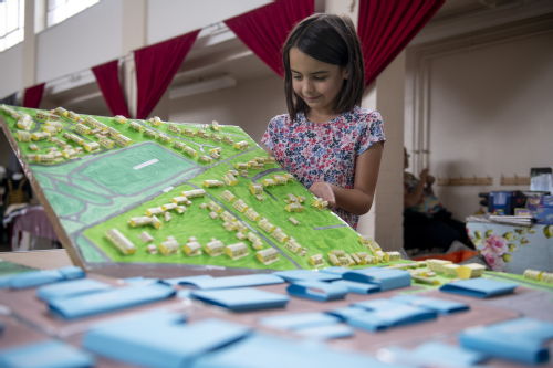 A young girl holding up a 3D map