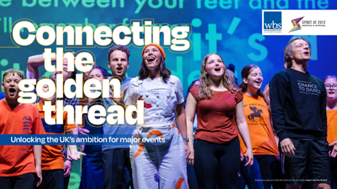 Young people on a stage smiling