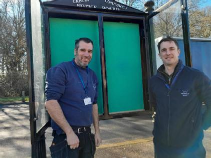 Estates colleagues in Canley with the noticeboard they fixed