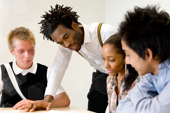 A group of professionals are looking at a document