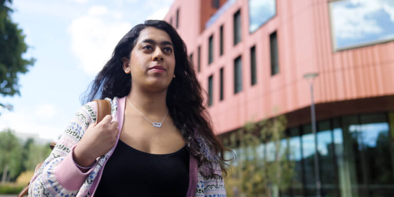 Staff member walking through campus