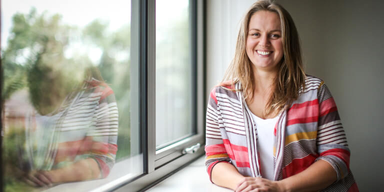 Staff member leaning on window