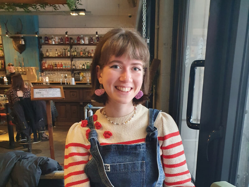 Polina in a bar smiling at the camera