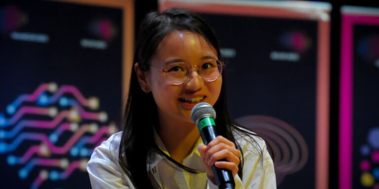 Student talking at an event