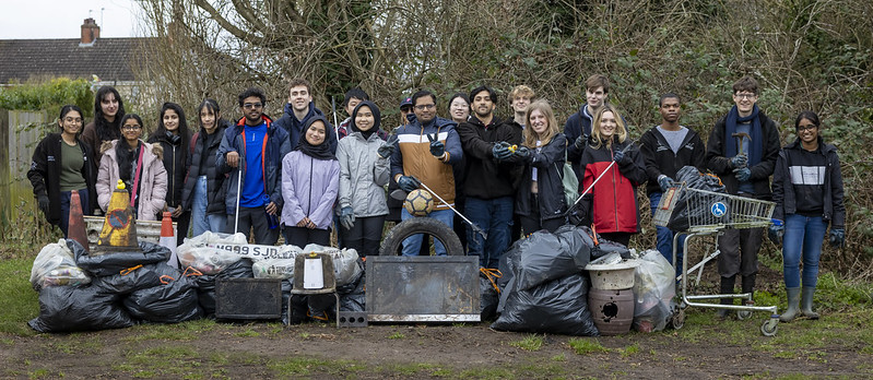 Group of volunteers in front of piles of litter