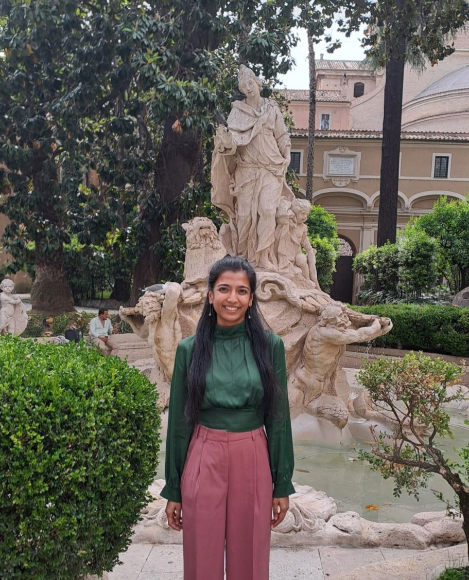 Juhie in front of a fountain