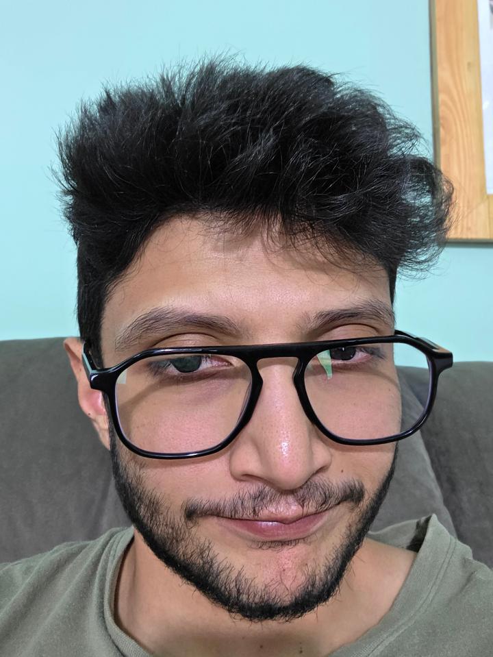 Arjun wears thick black glasses