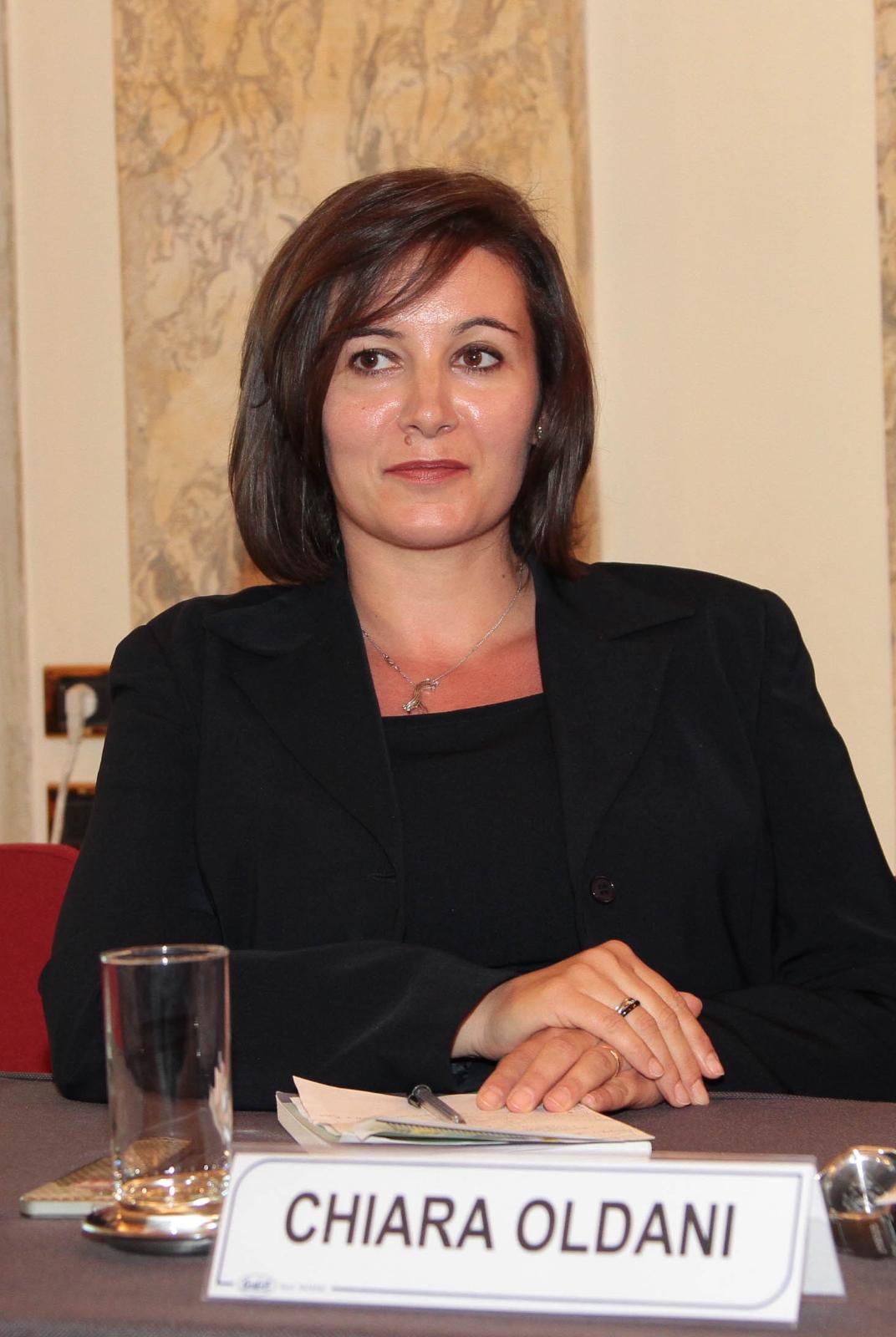 Chiara at a meeting with her name on the table