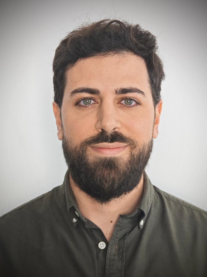 Constantinos smiles directly at camera
