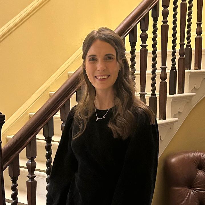 Kate stands before a staircase