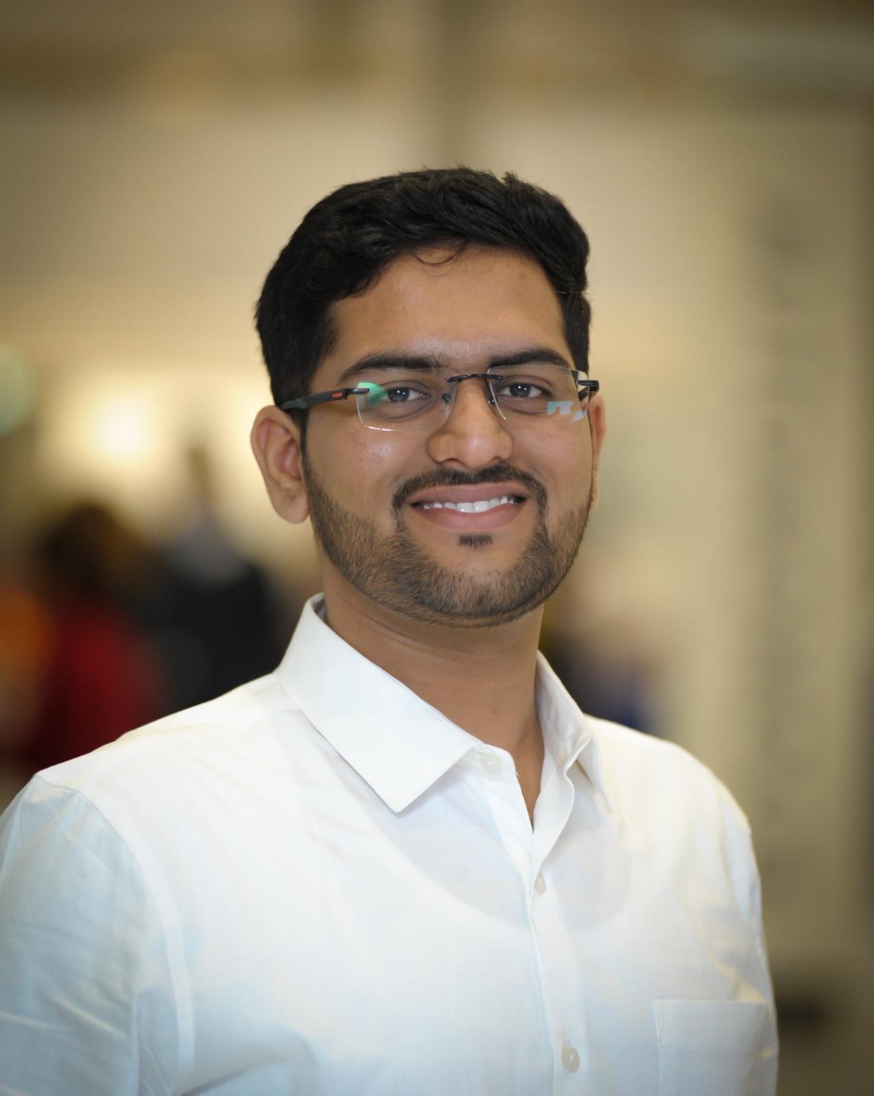 Manas Bedse wearing a white dress shirt