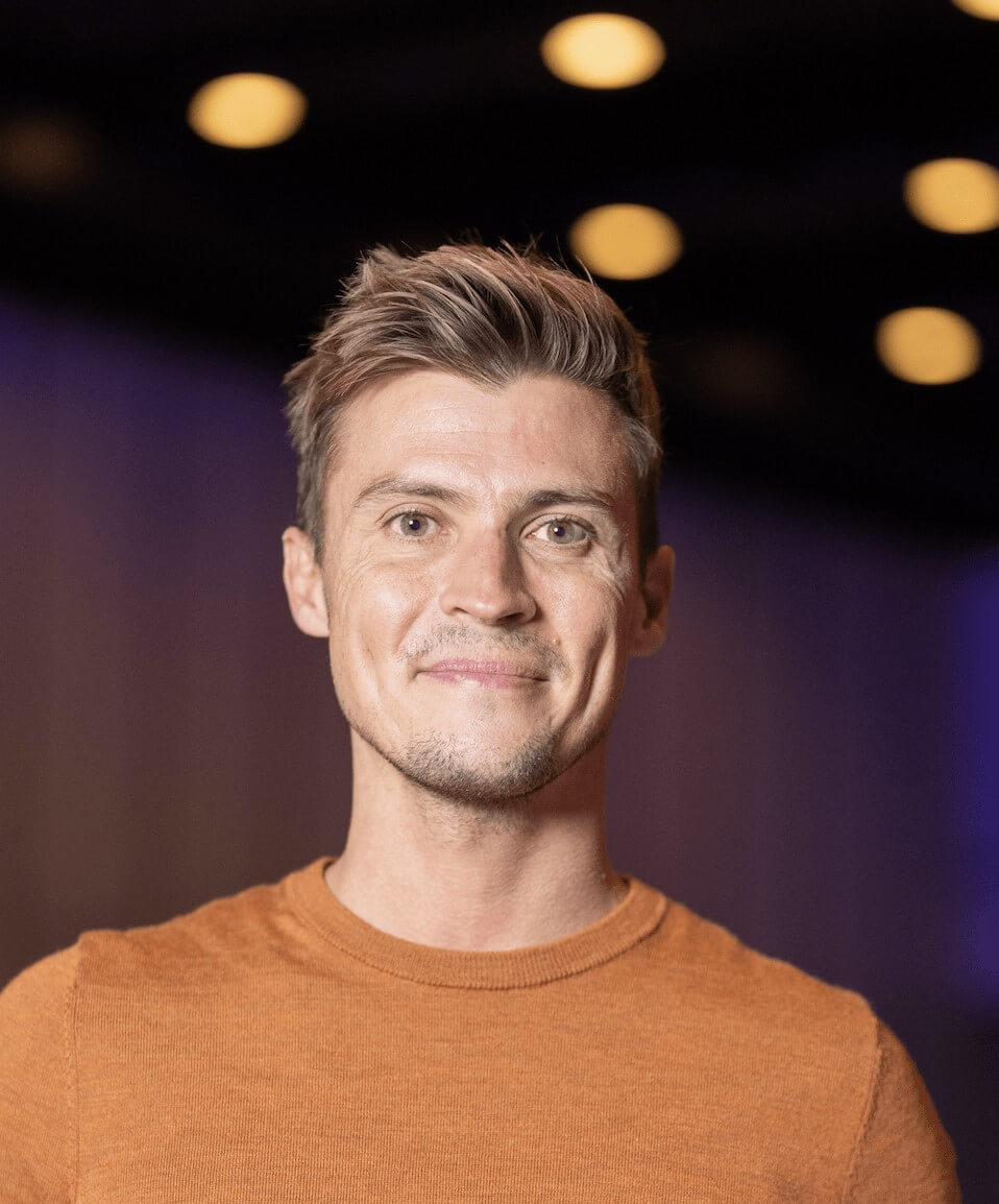 Max Beaumont in an orange t-shirt