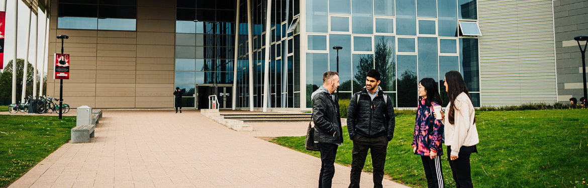 New Sports Centre with students standing outside.