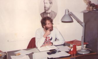 Celso at his desk thinking
