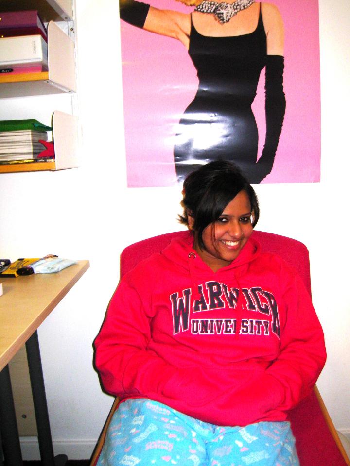  Neha Rajesh in dorm room wearing red Warwick hoodie