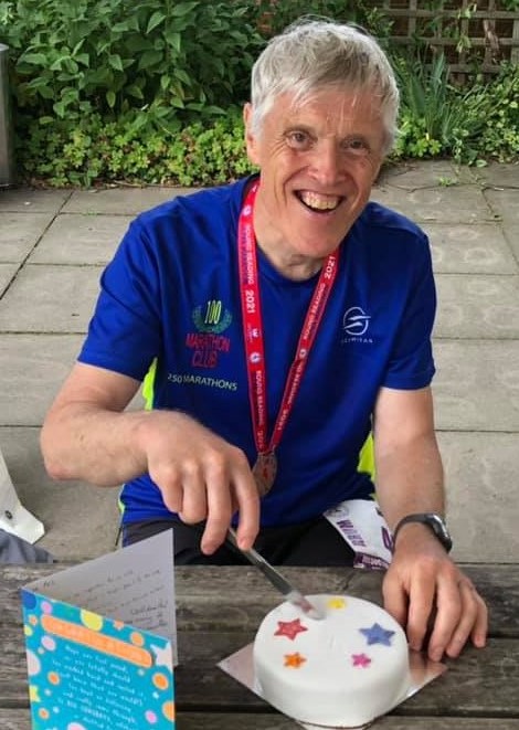 Phillip cutting his celebratory cake after the run