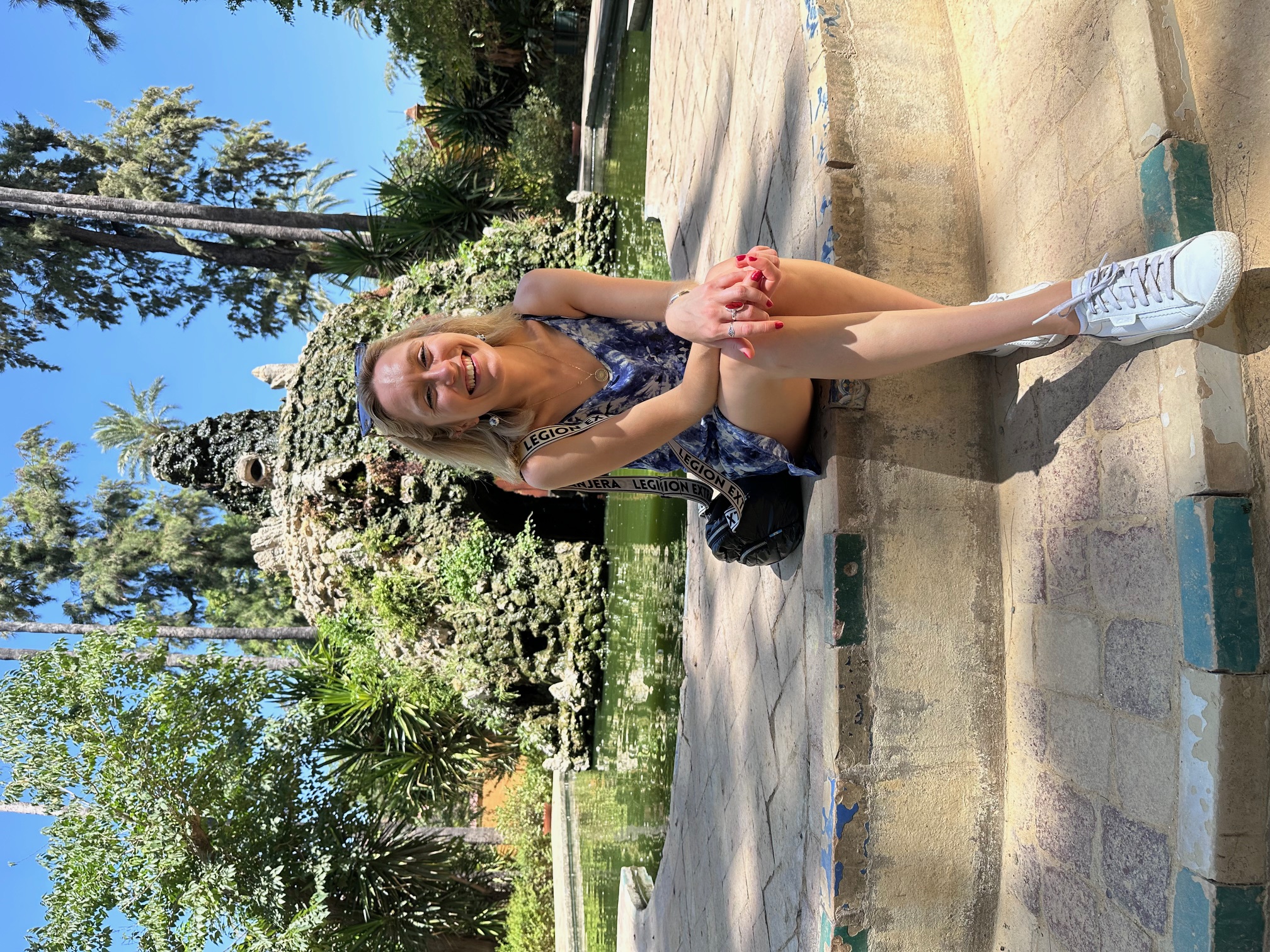Claudia sitting by a fountain