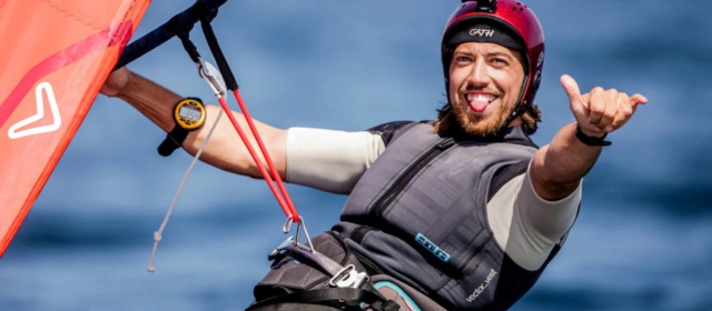 Windsurfing with his tongue sticking out