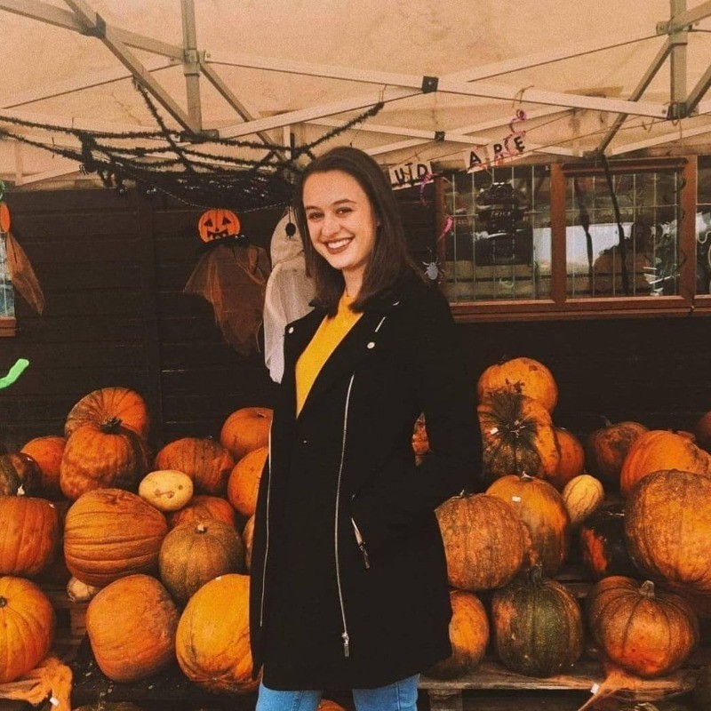 Michelle in front of some pumpkins