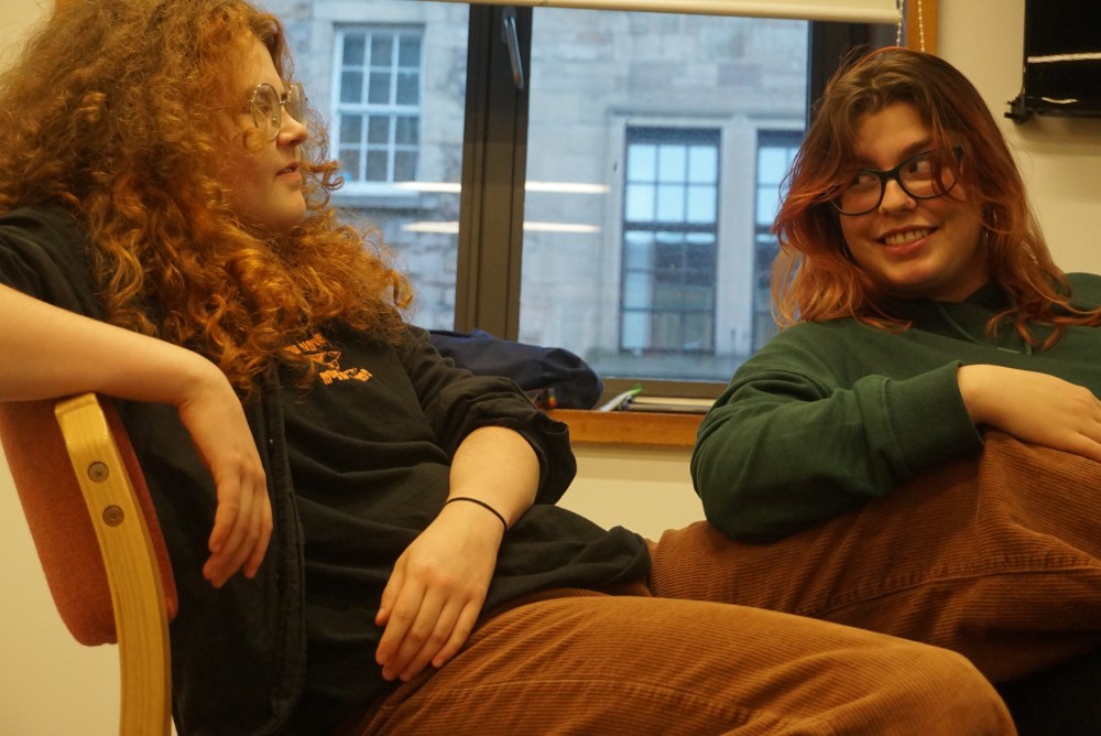 Two members of Speakbeast look towards each other away from camera