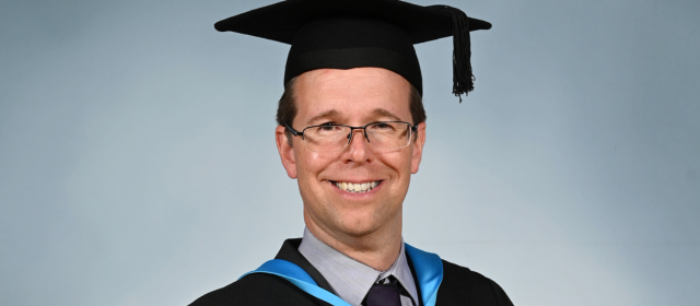 Andrew in his graduation robes