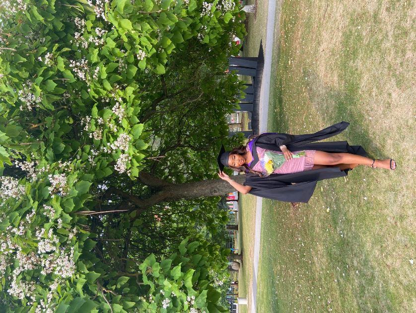 Jessica in her graduation robes on campus