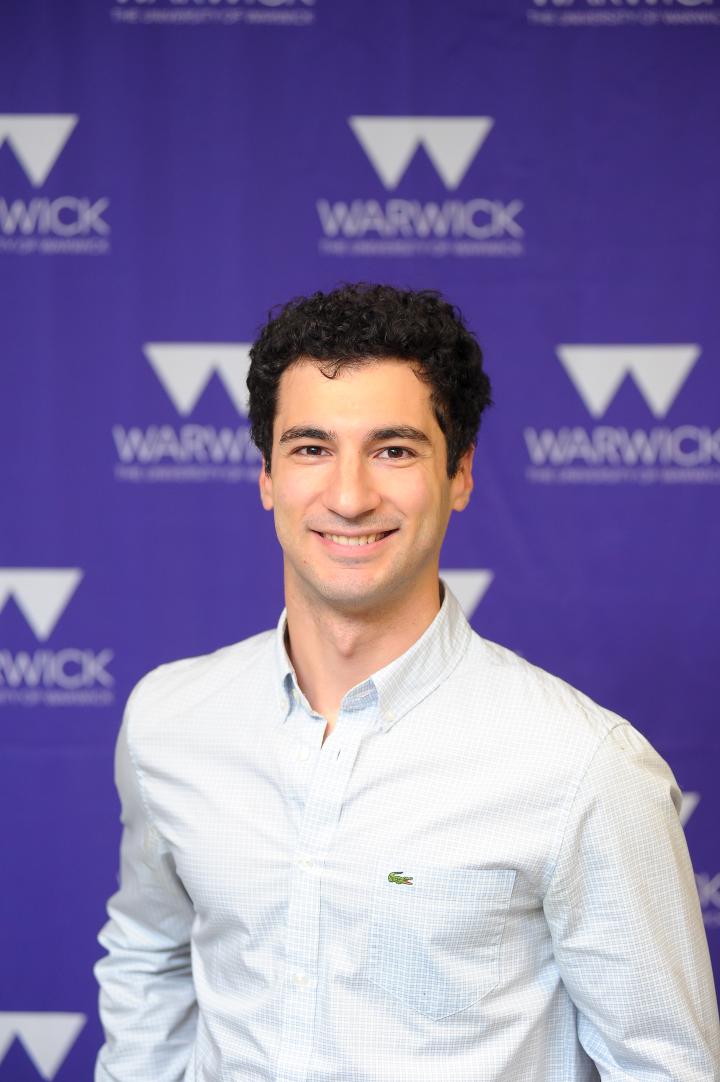 Diego stands before a Warwick stand