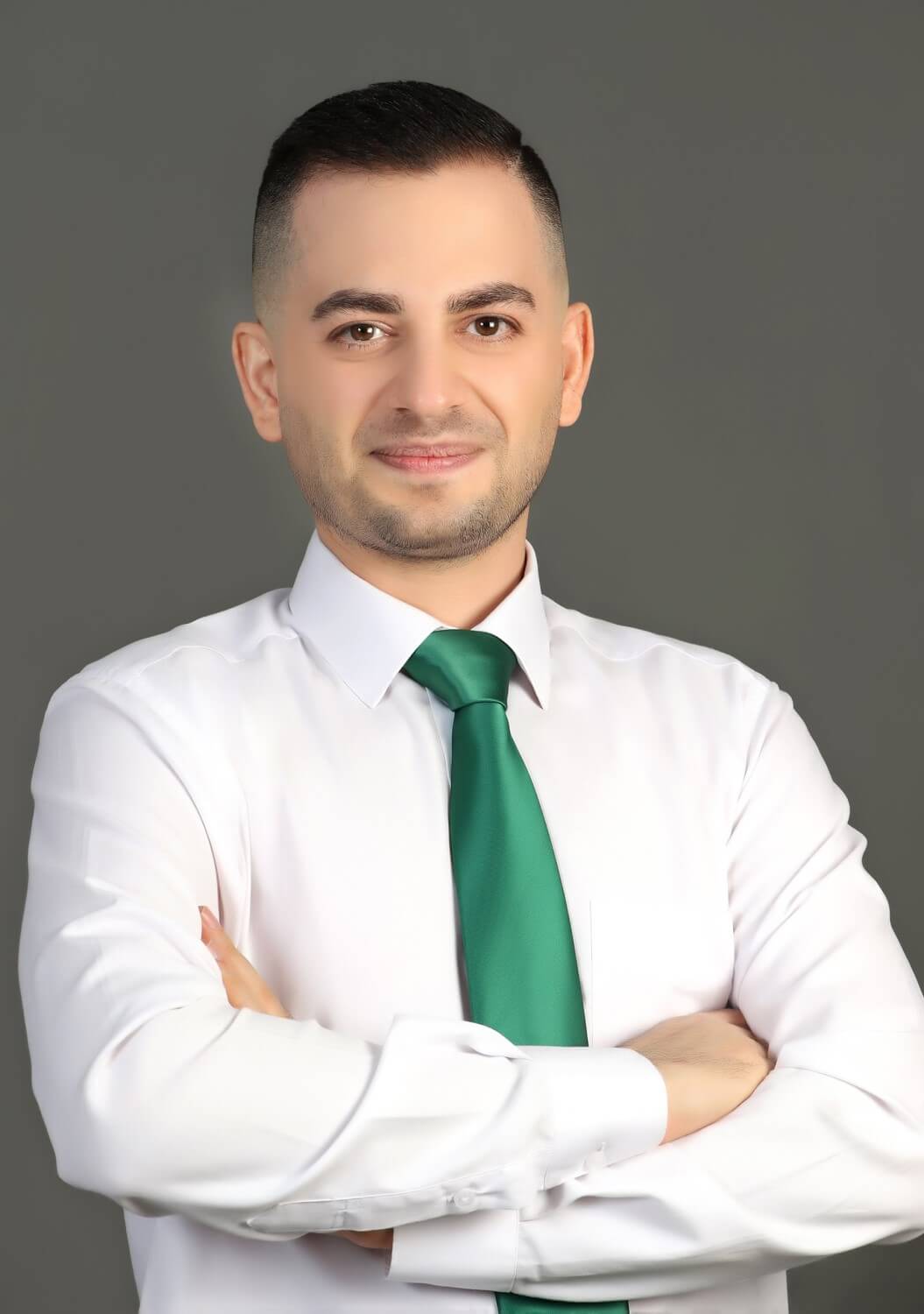 Mehdi Gholikhan in a white shirt with green tie