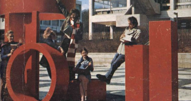 Students in the 70s on a campus art sculpture