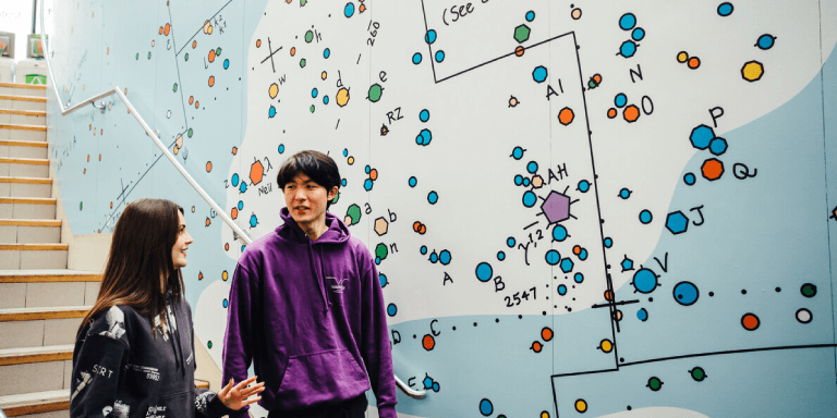 Students walking against map