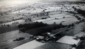 2. “The site from the air looking north east, 1964. The Central Campus is the middle distance; in the foreground is Cryfield House Farm, whose land formed the gift of the County. Its track joins Gibbet Hill Road. On the far right is part of Tocil Wood.”