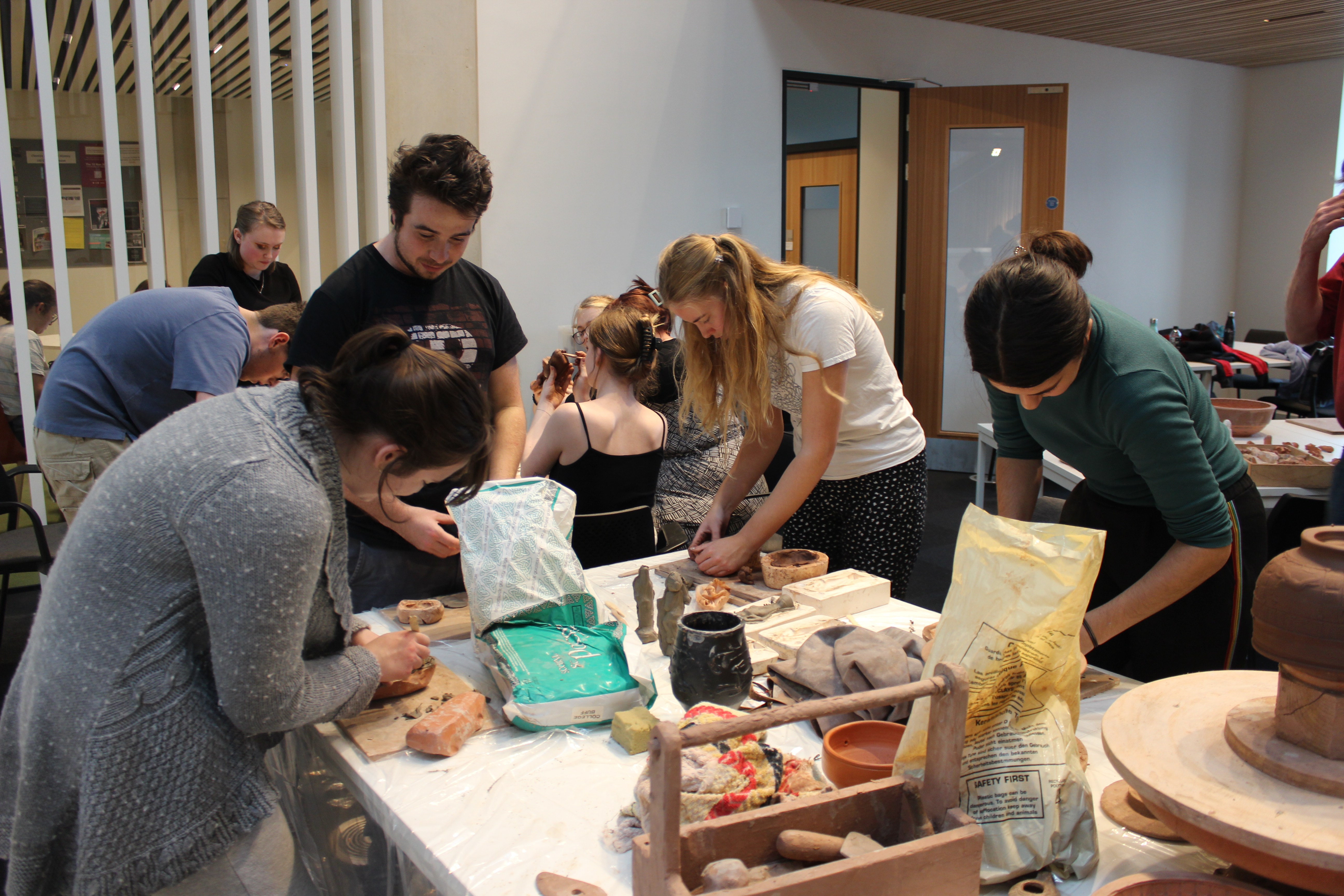 Photograph of Classics and Ancient History students working with clay