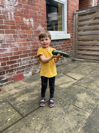 A very happy youngster with a huge courgette