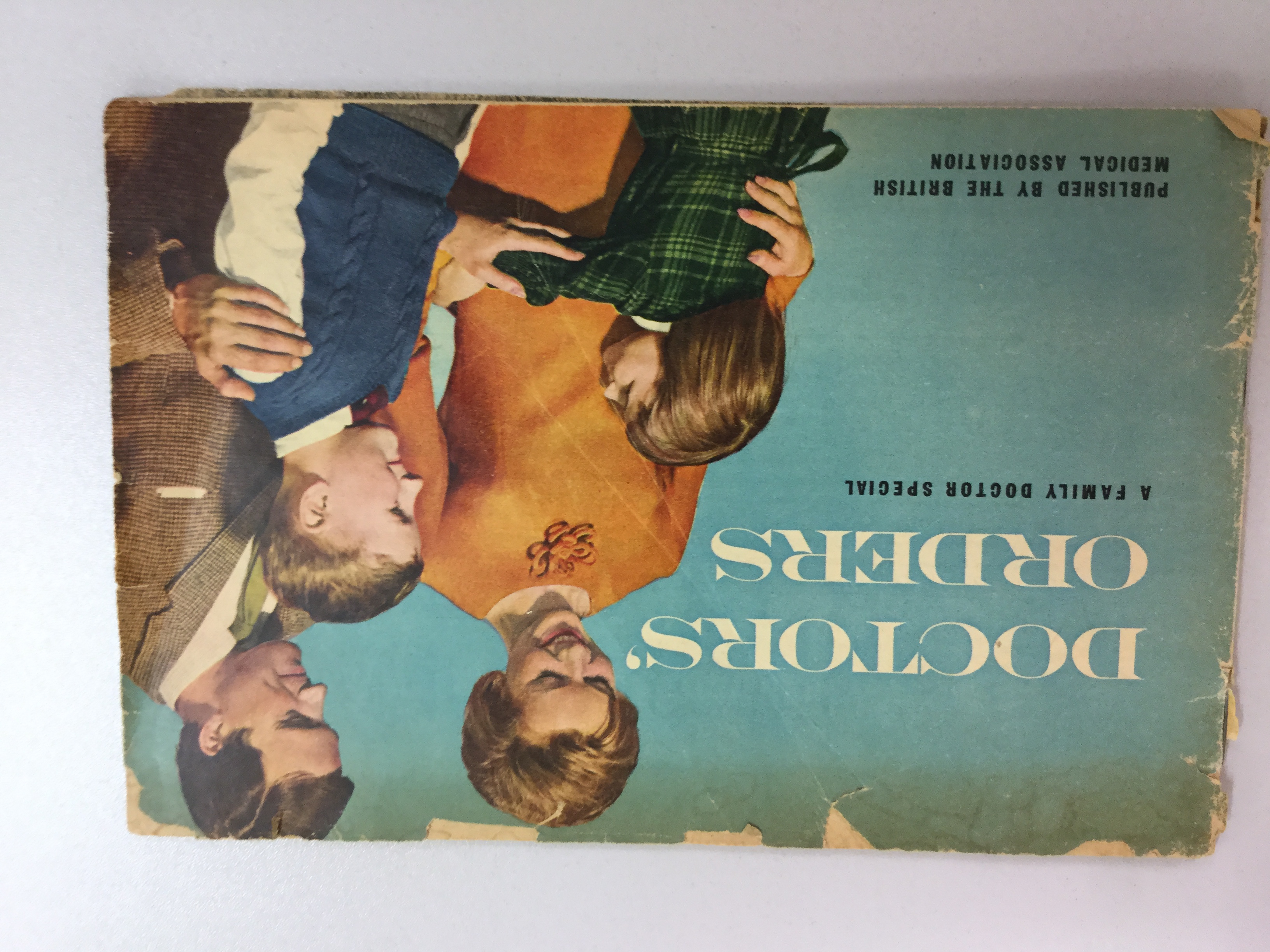 Cover Phototograph from BMA patient Magazine of the 1950s, entitled 'Doctor's Orders' and showing a middle-class White British nuclear family against a blue background.