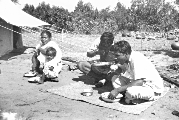 people eating outside their tent in India