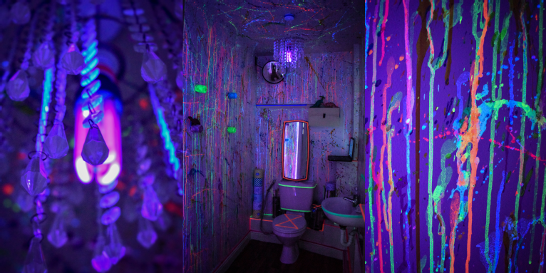 A series of three images in dark lighting with flourescent colours. The first is off a light fitting, taken from below so the lightbulb shows in a neon pink, reflecting off chandelier crystals hanging around it. The second photo shows a public bathroom covered in splatters of neon paint, the pain drips down the walls and ceiling. The toilet lid is down and a cross is painted over it in neon orange. The third image shows a close up of the neon paint streaks running down the wall.