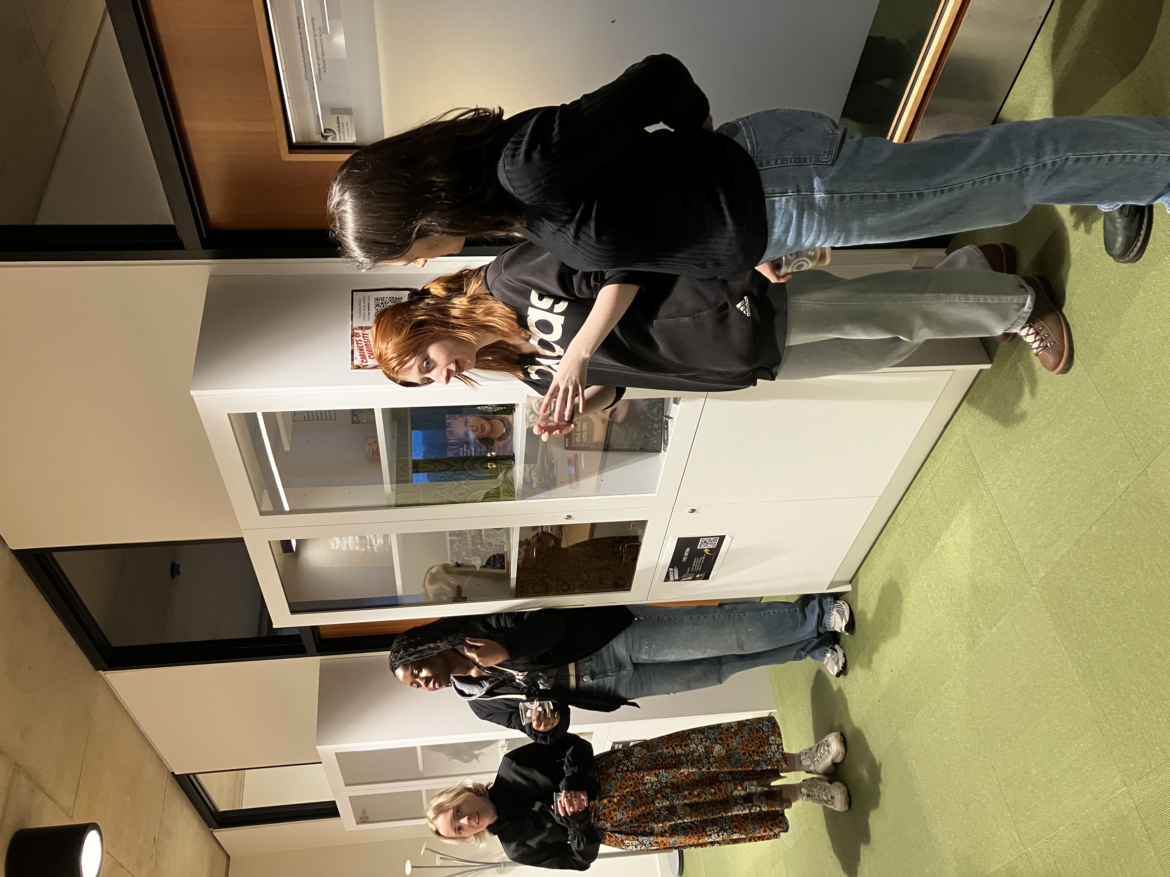 Students stood by a cabinet