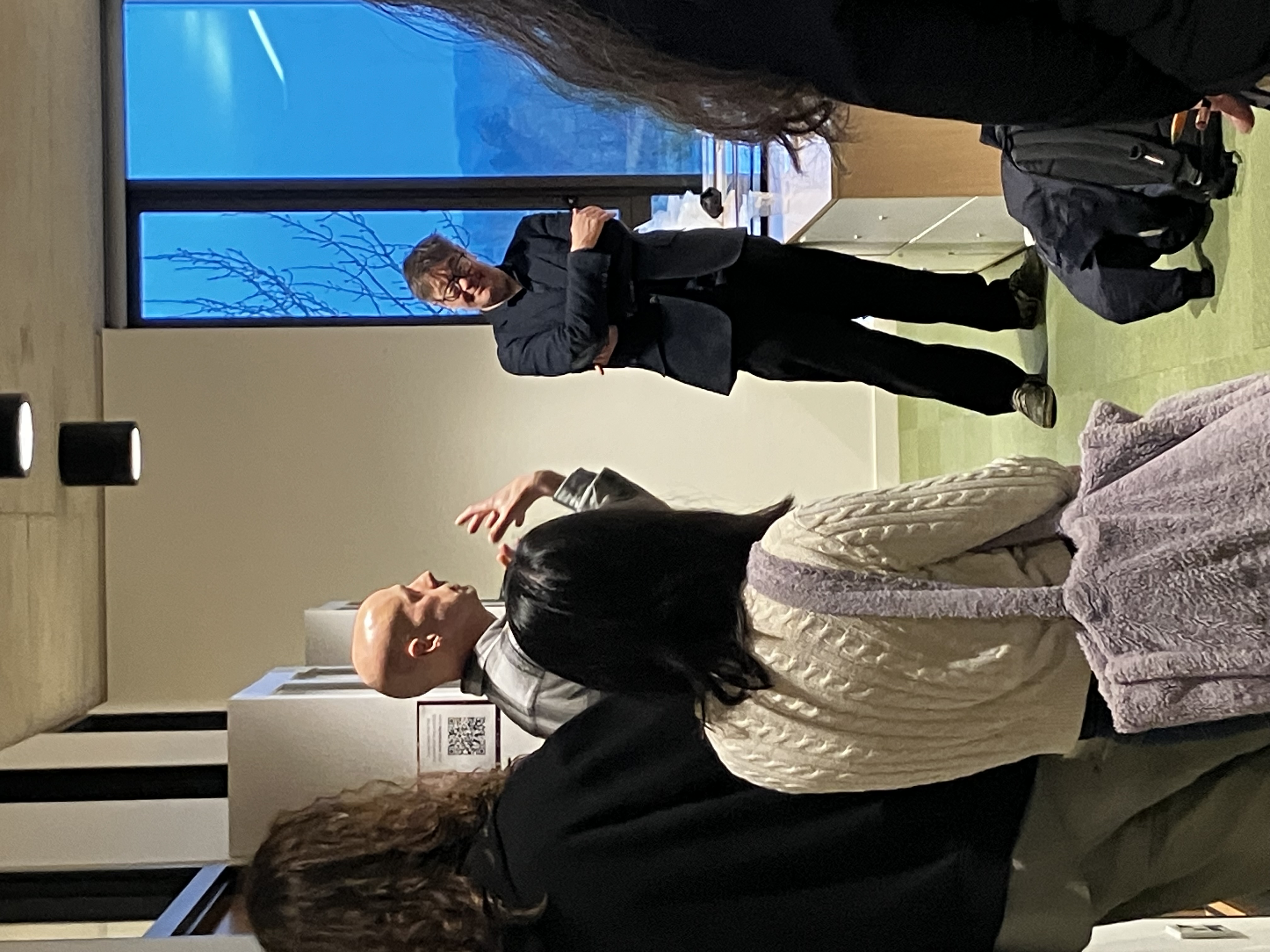 Cabinet curator talking to staff and students