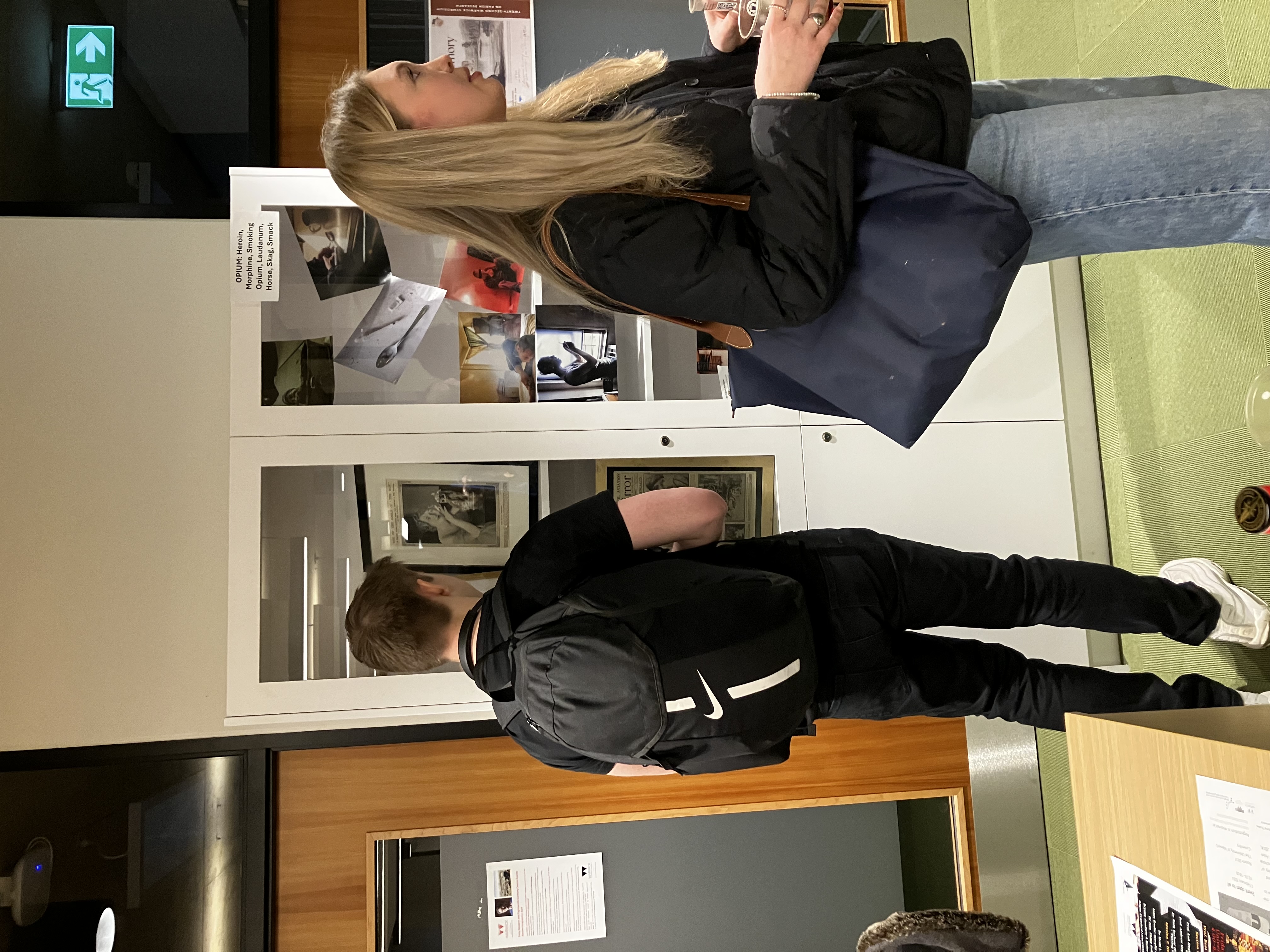 Students looking at items in a cabinet