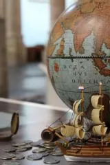 Globe with Dutch galleon and coins.