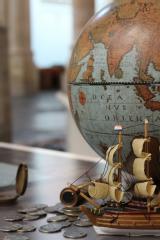 Globe with Dutch galleon and coins.