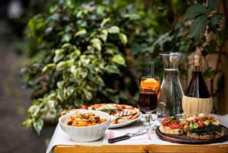 Picture of a wooden table laden with Italian food and wine