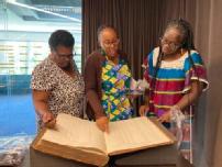 3 teachers looking at archival material