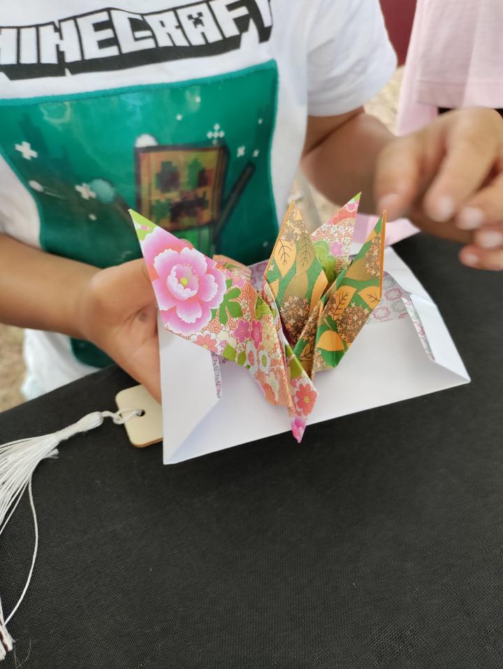 Participant showing off their origami creation