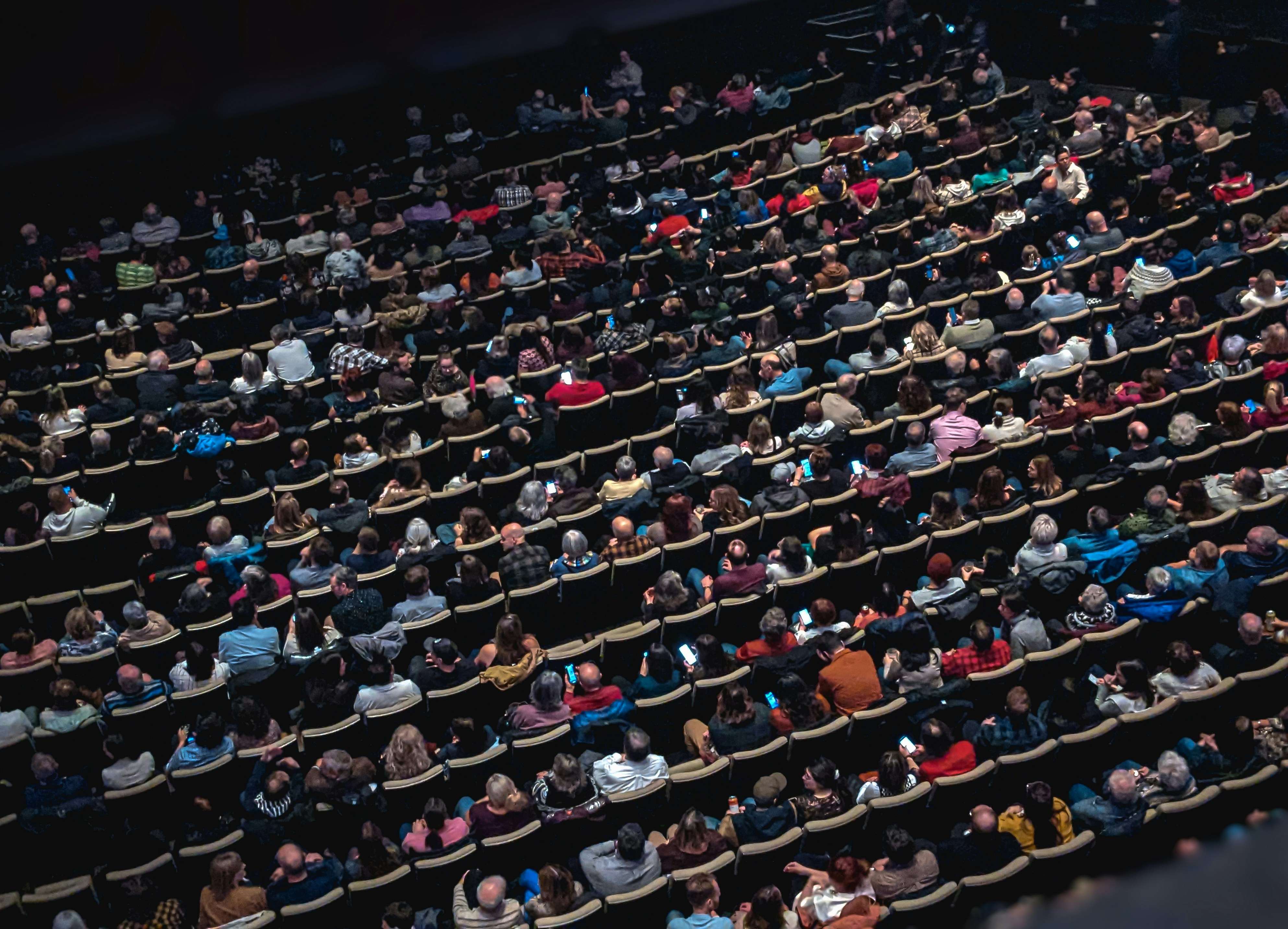 Large theatre audience seen from above.