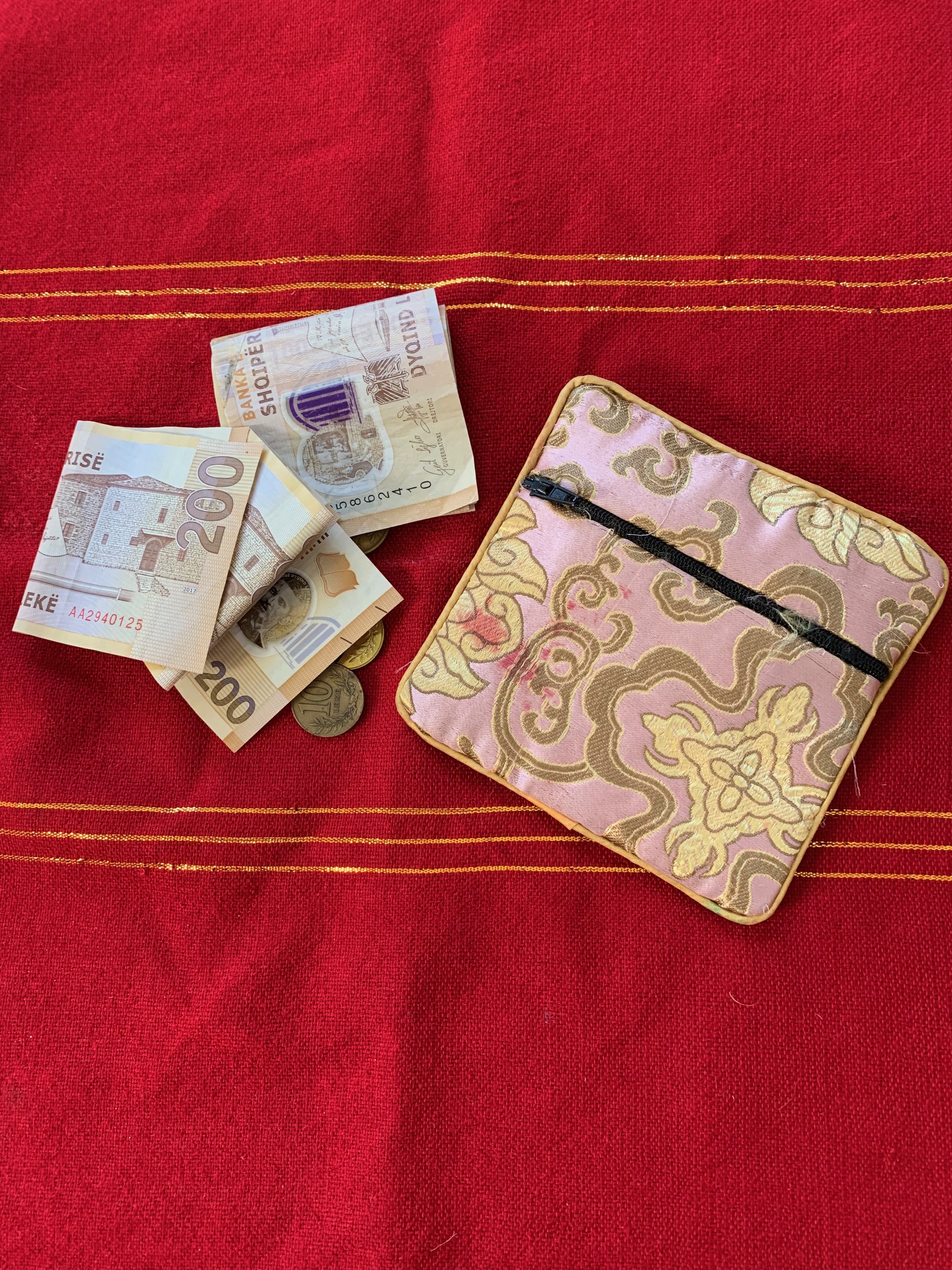 Fabric purse and Albanian notes and coins