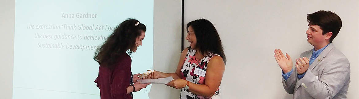 Anna Gardner receiving a certificate from Professor Cathia Jenainati