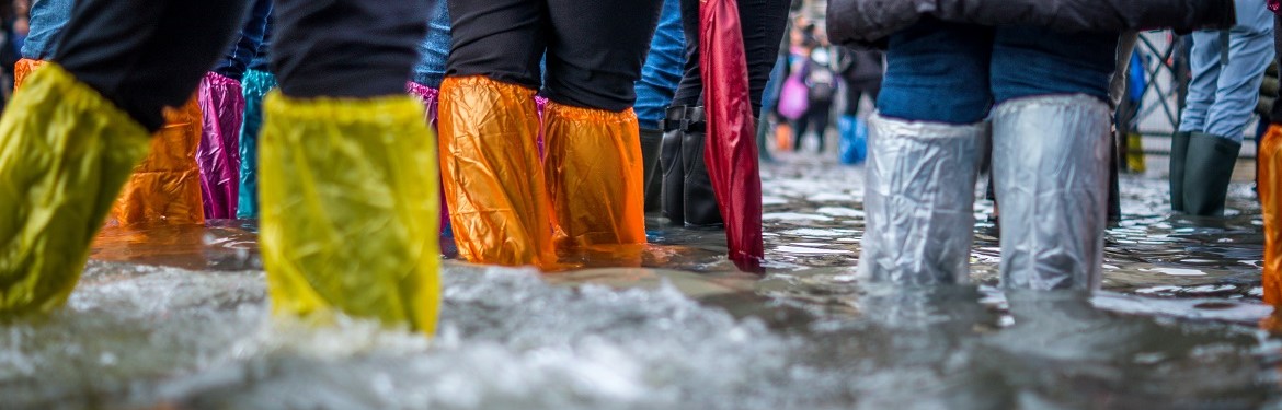 Tourists try to stay dry in a flooded St Mark’s Sq, venice